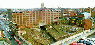 [View with church tower on horizon and river foreground]