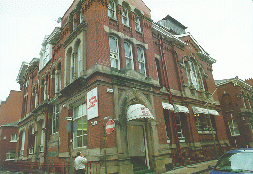 [Red brick building with stone decoration]
