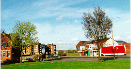 [view over a lawn onto a street]