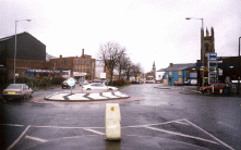 [mini roundabout church tower and road]