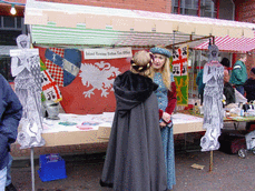 [women in costume and stall]
