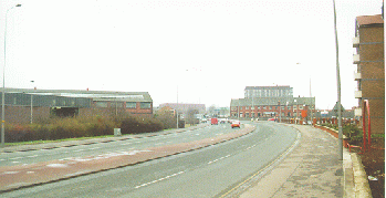 [dual carriageway with tower block in distance]